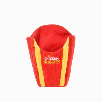 Dog toy designed as a red and yellow container for holding plush chicken nugget toys